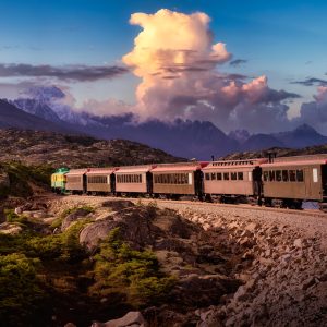 Old Historic Railroad Train is going over White Pass. Dramatic Colorful Sky. Skagway, Alaska, United States